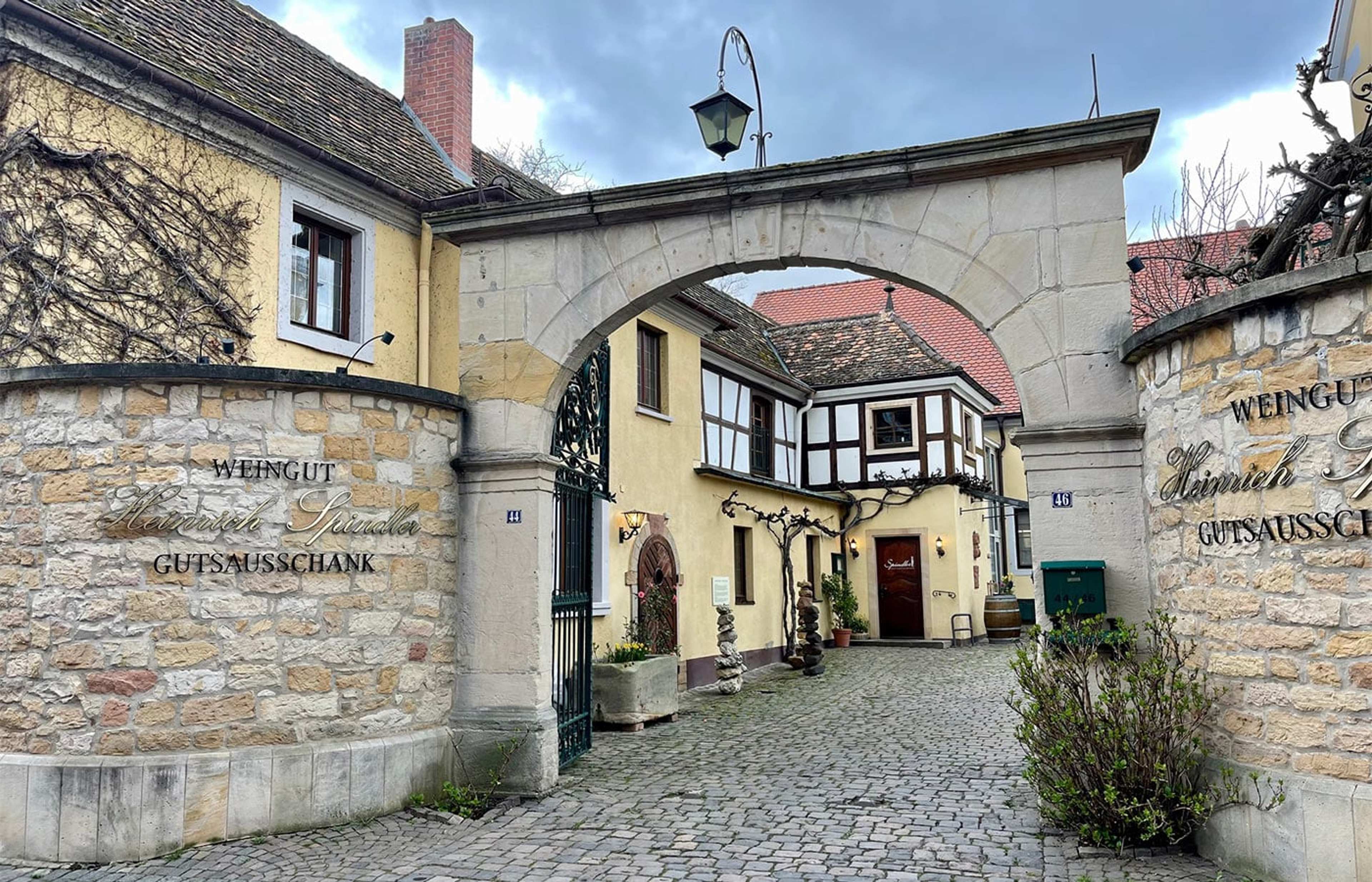 Steinernes Hoftor eines Weinguts mit gepflasterter Einfahrt